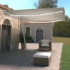 Toldo retráctil manual con luz LED crema 500x350 cm