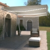 Toldo manual retráctil con LED color crema 600x350 cm